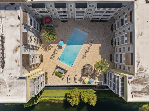 an aerial view of an apartment building with a swimming pool